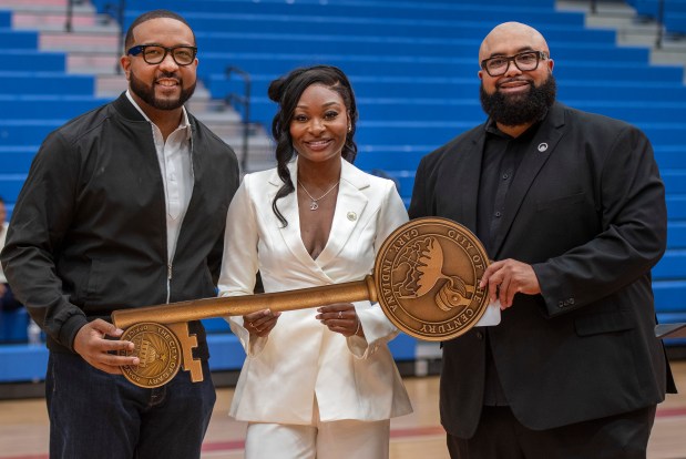 From left, Gary Mayor Eddie Melton, WNBA star and Gary native Dana Evans and mayoral advisor Markael Watkins display Evans' Key to the City at West Side Leadership Academy in Gary on Thursday, Oct. 30, 2025. (Michael Gard/for the Post-Tribune)