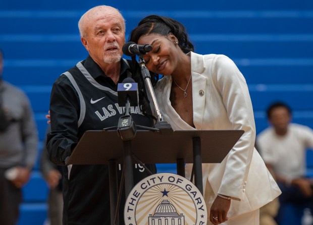 WNBA star and Gary native Dana Evans, right, puts her head on the shoulder of coach Rod Fisher as Evans receives the Key to the City at West Side Leadership Academy in Gary on Thursday, Oct. 30, 2025. (Michael Gard/for the Post-Tribune)