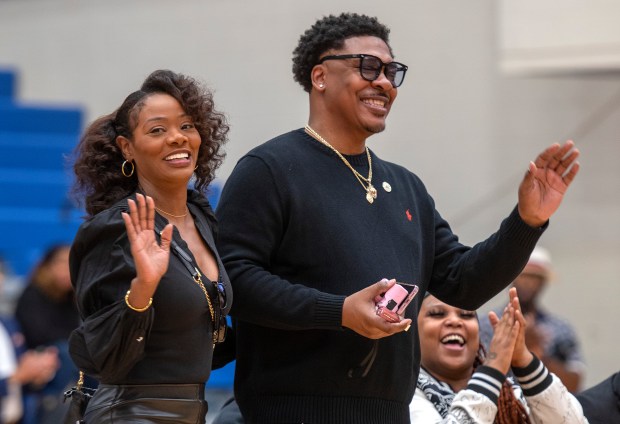 Shwanda & Damon Evans, the parents of WNBA star and Gary native Dana Evans, wave to the crowd during the ceremony for Dana to receive the Key to the City at West Side Leadership Academy in Gary on Thursday, Oct. 30, 2025. (Michael Gard/for the Post-Tribune)