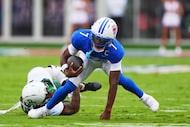 SMU quarterback Kevin Jennings (7) breaks a tackle against Baylor defensive lineman Jackie...
