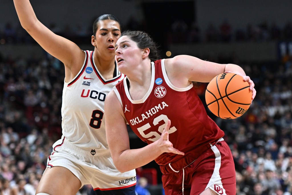 Oklahoma center Raegan Beers holds the ball in her left hand as she makes a move against UConn center Jana El Alfy.