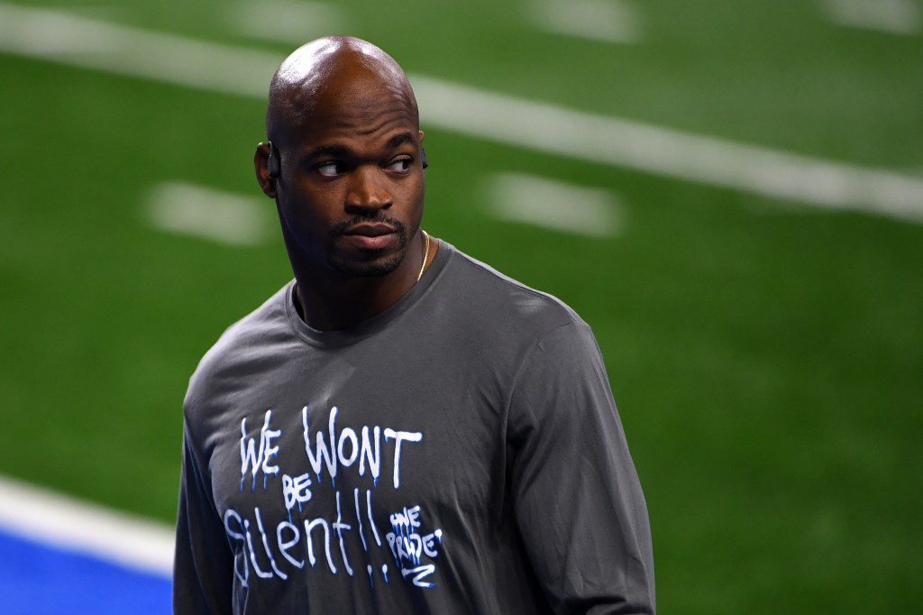 Adrian Peterson wearing a "We Won't Be Silent" shirt.