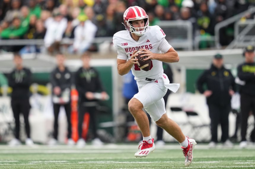 Indiana quarterback Fernando Mendoza runs out of the pocket during the Hoosiers' win over Oregon on October 11.