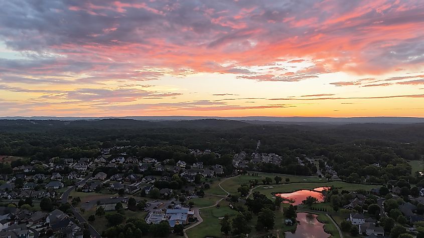 Sunset over wedding on golf course.