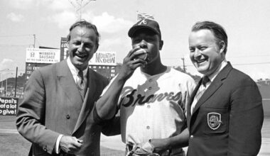 Hank Aaron kisses the baseball used for his 3,000th hit in Cincinnati May 17, 1970. At left is Hall of Famer Stan Musial who was the last man to accomplish the feat in 1958. Aaron achieved the milestone with a single off Cincinnati Reds pitcher Wayne Simpson.