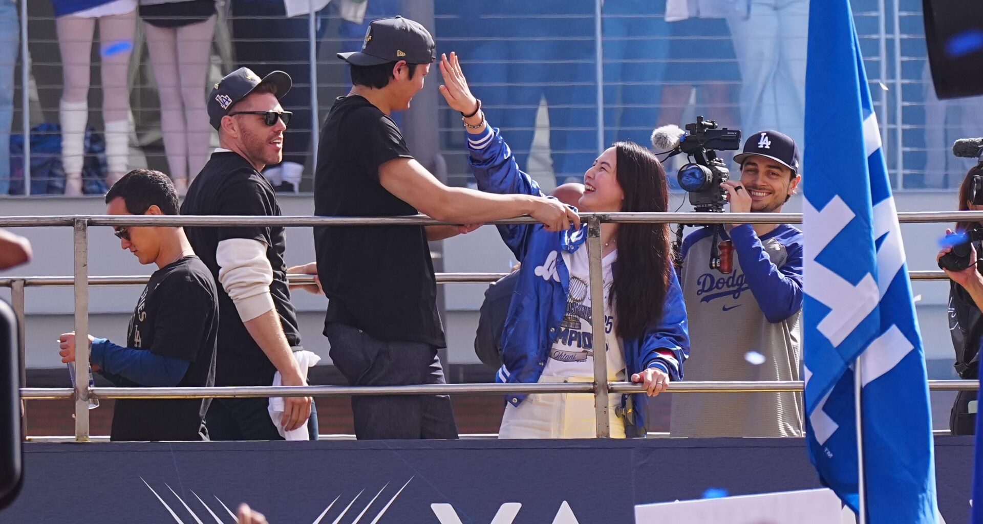 Mamiko shields her husband's eyes from a "Shohei Ohtani Marry My Mom" sign