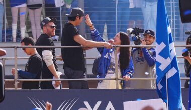 Mamiko shields her husband's eyes from a "Shohei Ohtani Marry My Mom" sign
