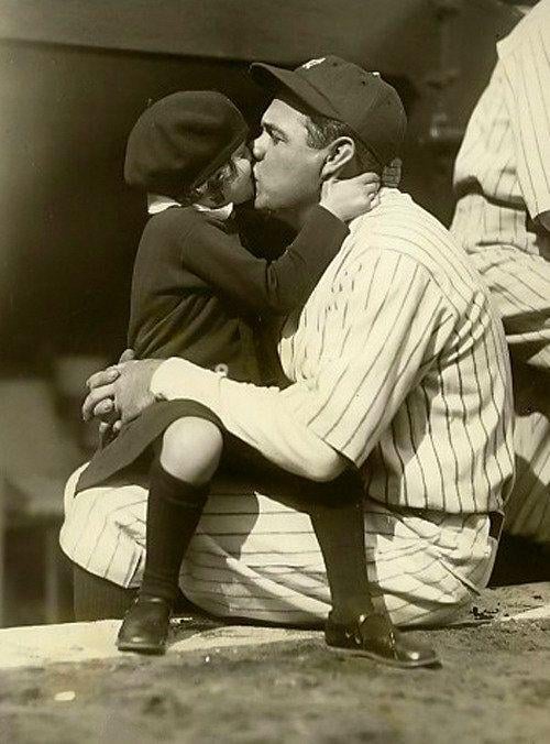 Babe Ruth gets a good luck kiss from his daughter before Game 3 of the 1927 World Series. Ruth hit a three run homer in the game as the Yankees won 8-1.
