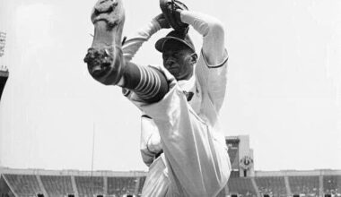 Satchel Paige in to his windup with a high leg kick at Cleveland Municipal Stadium in 1948. In his 1948 season with Cleveland, he went 6-1 with a 2.48 ERA and helped the team win the American League pennant and the World Series, becoming the first African-American to pitch in a World Series game.