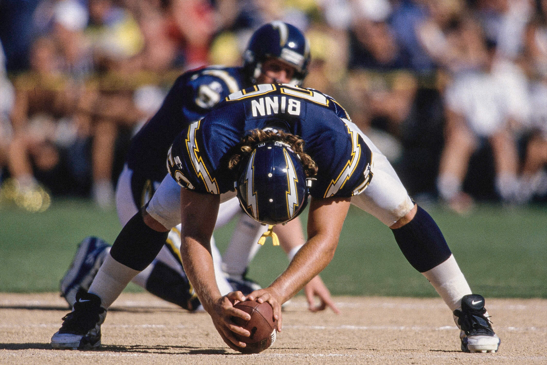 David Binn, in a blue San Diego Chargers jersey, prepares to snap the ball in 1996.