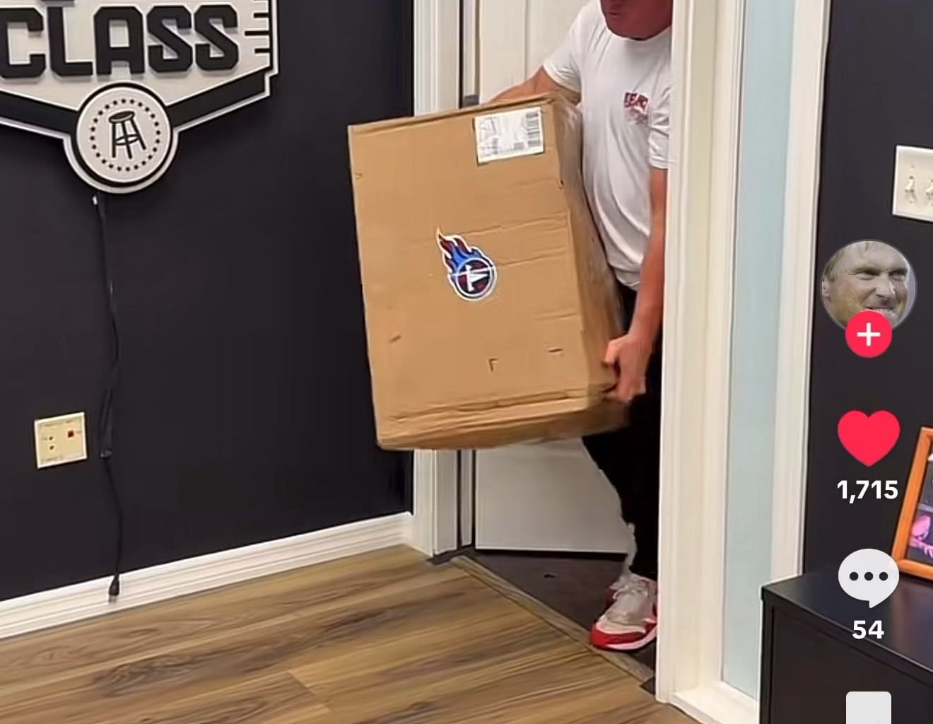 Jon Gruden opening a box of goods sent from the Tennessee Titans.