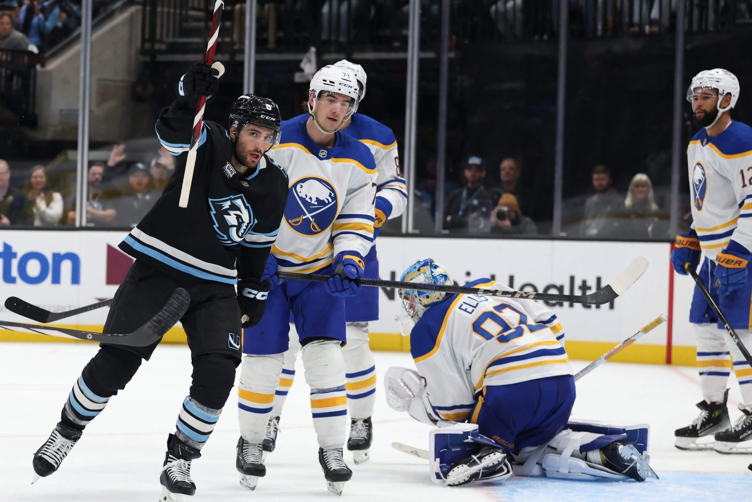 Utah Mammoth center Nick Schmaltz, left, celebrates a goal against goalie Colten Ellis, second from right, and the Buffalo Sabres.the Buffalo Sabres during the third period at Delta Center. Mandatory Credit: Rob Gray-Imagn Images