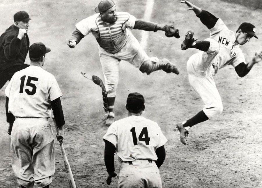 Dodgers catcher Roy Campanella on October 2, 1953 secures the final out of Game Four of the World Series by knocking Yankees second baseman Billy Martin away from the plate. The moment captures the intensity of the legendary Dodgers-Yankees rivalry.