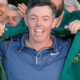 Rory McIlroy putting on green jacket after winning The Masters