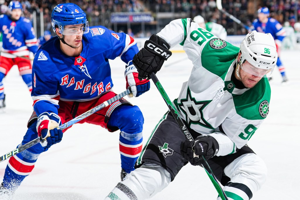 Braden Schneider (right) defends Mikko Rantanen during the Rangers' OT win over the Stars on Dec. 2, 2025.