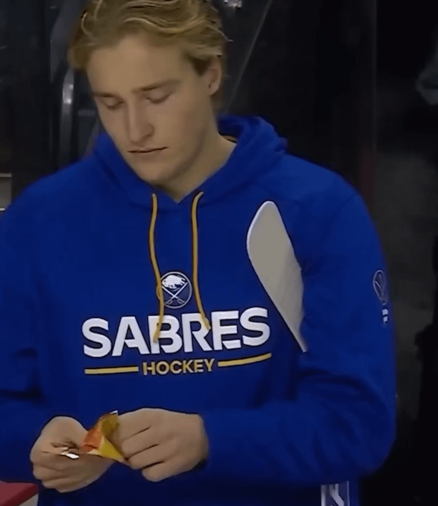Ukko-Pekka Luukkonen takes a couple nibbles out of a bar, and then proceeds to carefully inspect it, and then wrap it up with a ton of hockey tape.