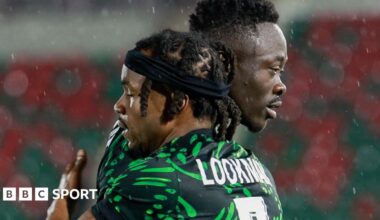 Semi Ajayi, wearing an all-green Nigeria kit, peels away in celebration after scoring for Nigeria. He is followed by team-mate Akor Adams, with Bright Osayi-Samuel trailing further behind