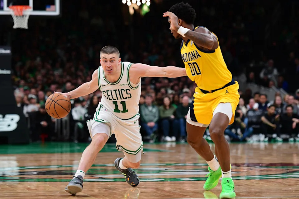 Dec 29, 2024; Boston, Massachusetts, USA; Boston Celtics guard Payton Pritchard (11) controls the ball while Indiana Pacers guard Bennedict Mathurin (00) defends during the first half at TD Garden. Mandatory Credit: Bob DeChiara-Imagn Images