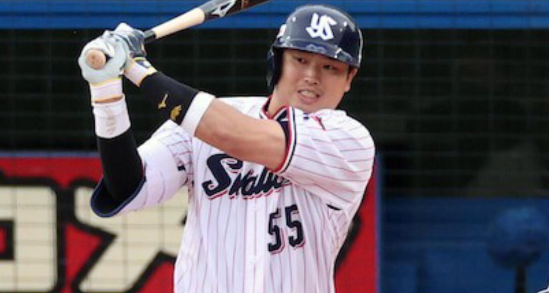 Why do NPB players uniforms have their team names in English?