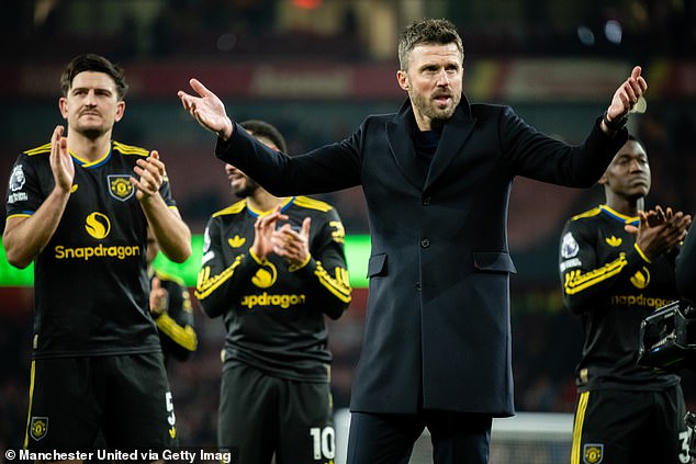 Michael Carrick celebrates in front of the Man United fans - and his children - at Arsenal