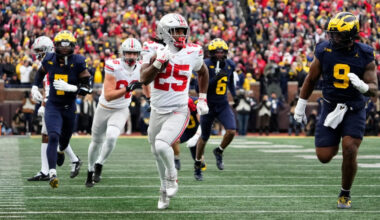 Ohio State Buckeyes running back Bo Jackson (25) runs past Michigan Wolverines defensive end Cameron Brandt (9) during the NCAA football game at Michigan Stadium in Ann Arbor, Mich. on Nov. 29, 2025. Ohio State won 27-9.