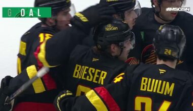 Brock Boeser scores a goal against the New Jersey Devils