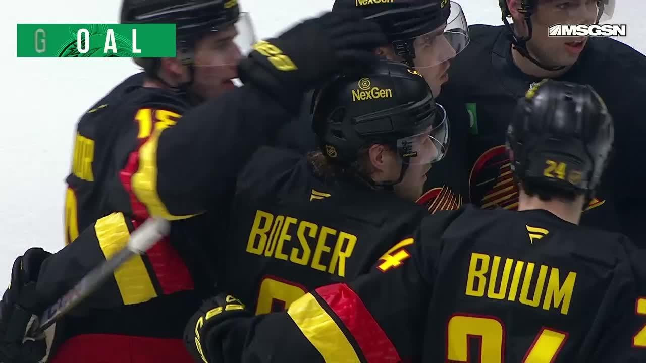 Brock Boeser scores a goal against the New Jersey Devils