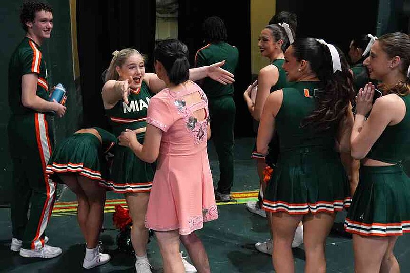 Miami cheerleaders react as they meet Red Panda after she performed at halftime of an NCAA college basketball game between Miami and Stanford in Coral Gables, Fla., Wednesday, Jan. 28, 2026. (AP Photo/Rebecca Blackwell)