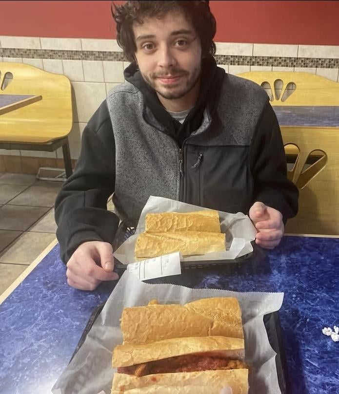 Quinn Hughes enjoying a sandwich before the game