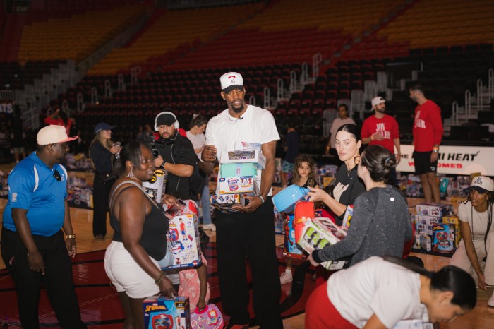 Bam Adebayo holding boxes of presents at his holiday toy drive.