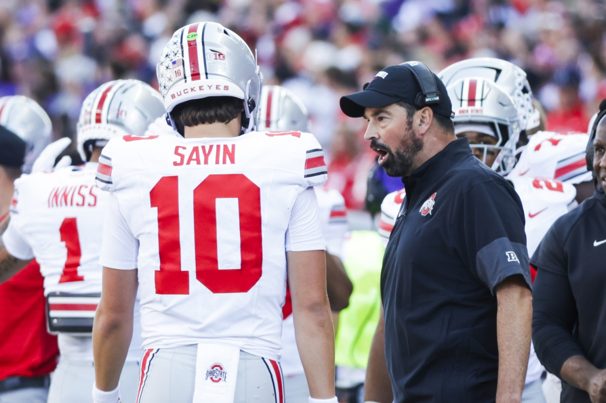 Sep 27, 2025; Seattle, Washington, USA; Ohio State Buckeyes head coach Ryan Day speaks with quarterback Julian Sayin (10) during a fourth quarter timeout against the Washington Huskies at Husky Stadium. Mandatory Credit: Joe Nicholson-Imagn Images