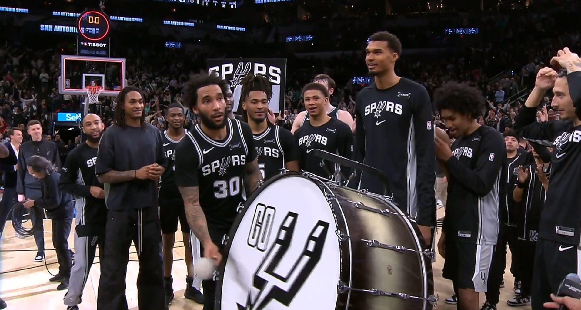 Julian Champagnie is grabbed from his jersey, taken by BIsmack Biyombo to do the new Spurs tradition with the drum, after scoring a career-high 11 threes, setting also a franchise record