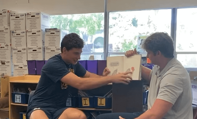 Fernando Mendoza reading to bilingual Berkeley kids early in his Cal career