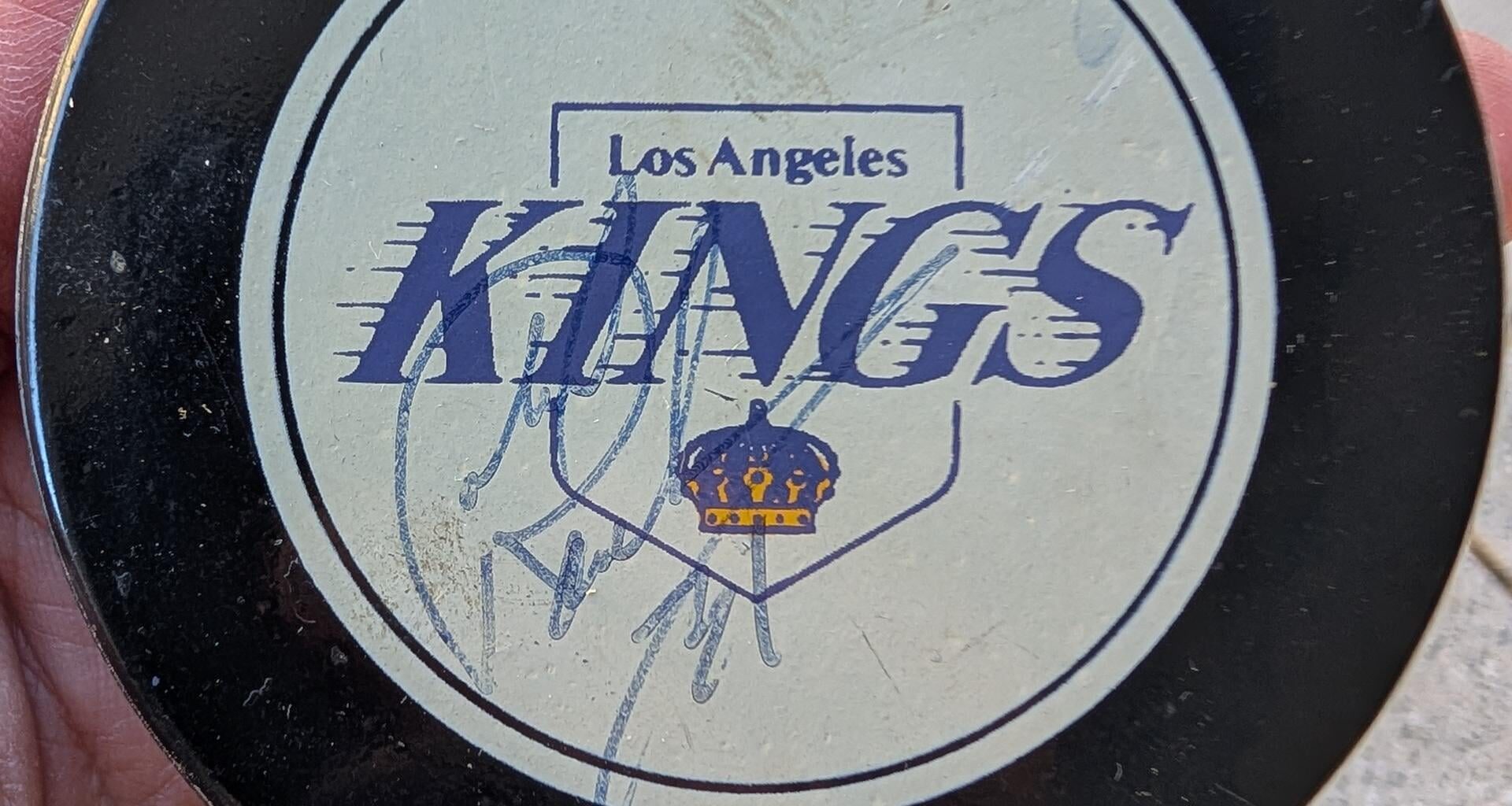 Found this autographed puck from the 90s while cleaning out my garage. Any idea whose autograph it is?