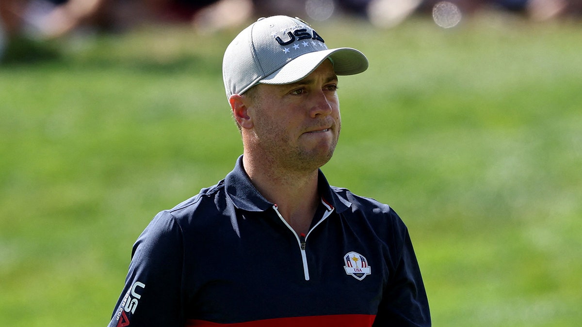 Justin Thomas looks on
