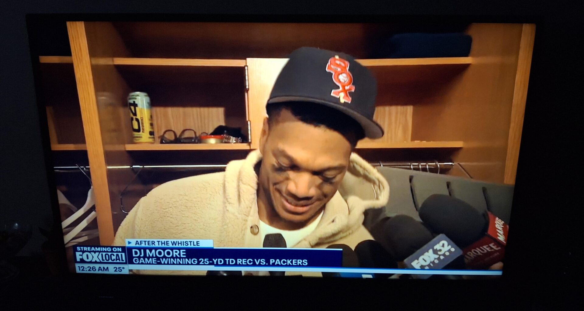 DJ Moore rocking a Sox hat in the locker room after beating the Packers
