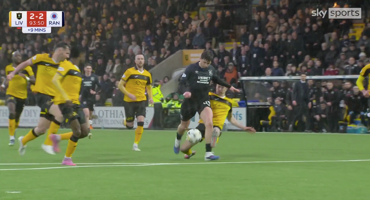 Rangers star Mikey Moore is tackled by Cammy Kerr of Livingston