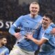 Erling Haaland celebrates making it 3-0 with Phil Foden