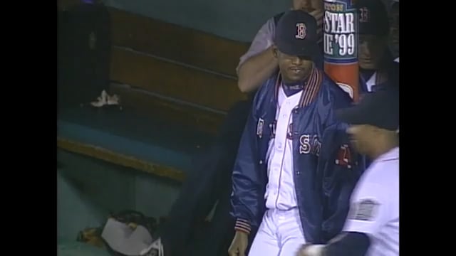 Nomar Garciaparra and Mark Portugal use tape to tie Pedro Martinez to a pole in the dugout at Fenway Park