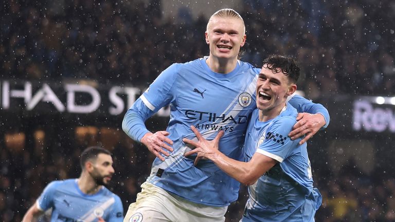 Erling Haaland celebrates making it 3-0 with Phil Foden