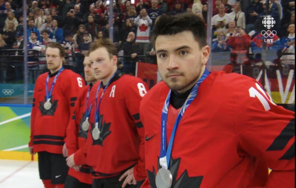 A disappointed Nick Suzuki gets his Olympic silver medal with Team Canada