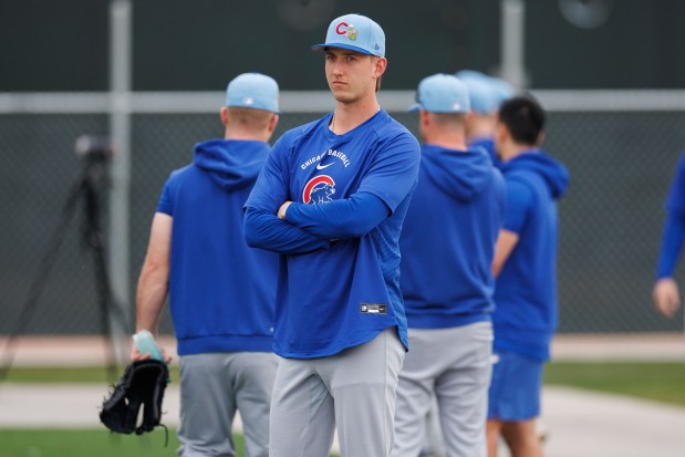 Ben Brown stands with other Cubs pitchers before warming up during the first full-squad workout at spring training Feb. 16, 2026, at Sloan Park in Mesa, Ariz. (Armando L. Sanchez/Chicago Tribune)