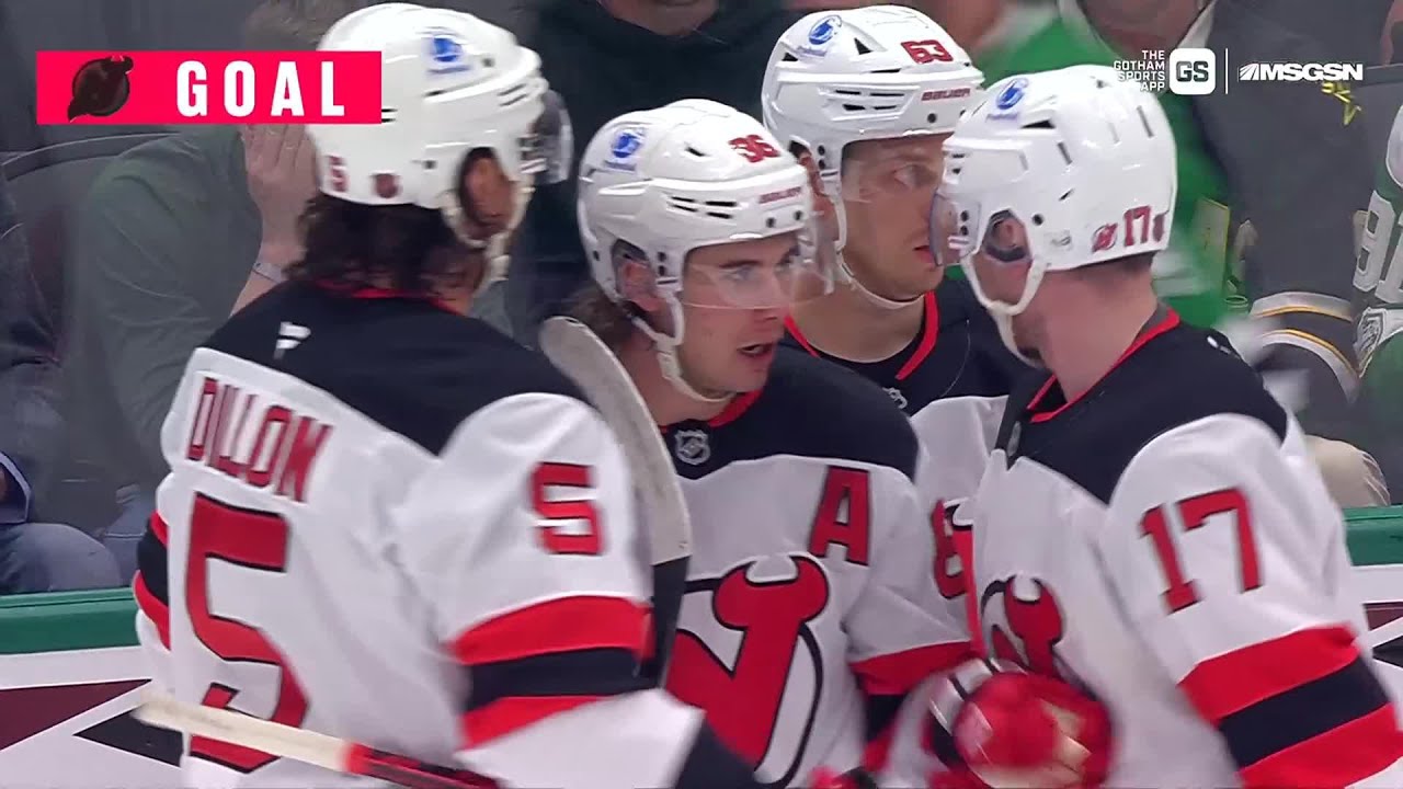 Jack Hughes scores a goal against the Dallas Stars