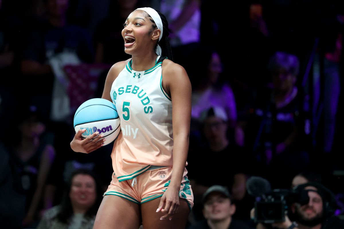 Angel Reese of Rose in Unrivaled smiling while holding the basketball