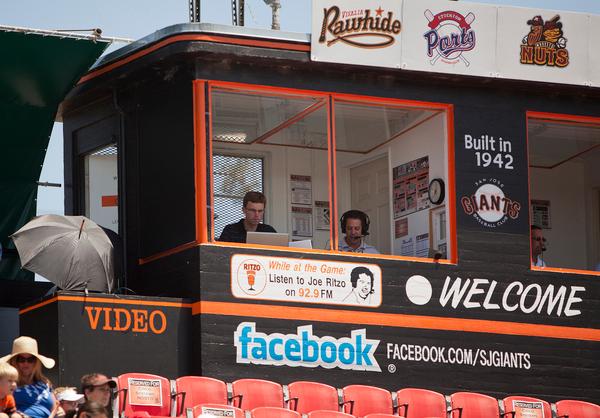 From left, Ben Taylor inputs a running pitch-by-pitch summary to the San Jose Giants mobile app as Joe Ritzo broadcasts play-by-play on the radio as the Giants play the Lake Elsinore Storm at the Municipal Stadium in San Jose, Calif. on Tuesday July 9, 2013. (LiPo Ching /Bay Area News Group)