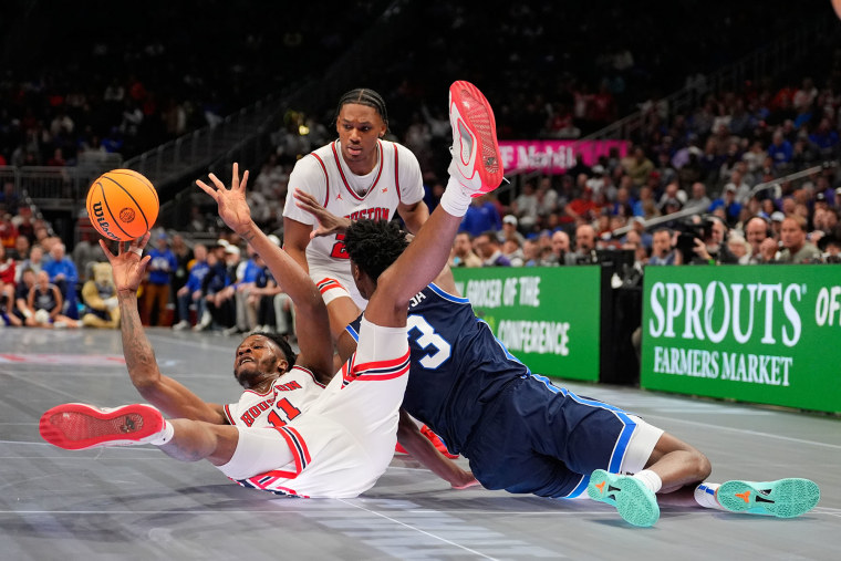 Houston's Joseph Tugler falls on the court during against BYU on Thursday, March 12, 2026, in Kansas City, Mo. 