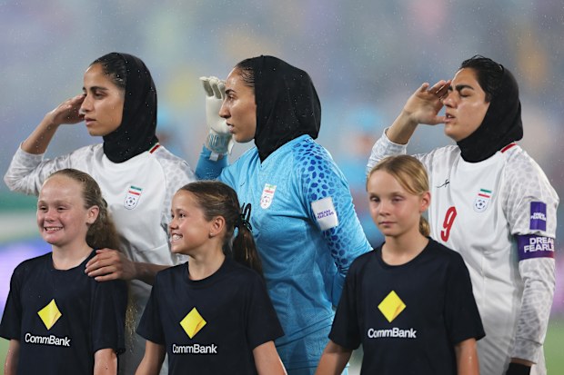 Iran players line up for national anthems prior to the game against Australia.