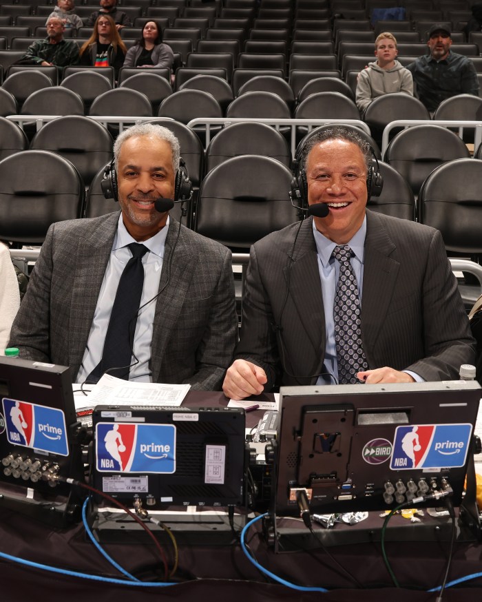 Broadcasters Dell Curry and Eric Collins pose for a photo