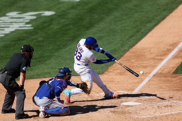 Chicago Cubs shortstop Jefferson Rojas hits a sacrifice RBI during the fourth inning against the Texas Rangers in a Cactus League game at Sloan Park on Saturday, Feb. 21, 2026, in Mesa, Ariz. (Armando L. Sanchez/Chicago Tribune)