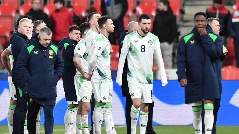 Itaeland's players walk off the pitch after defeat